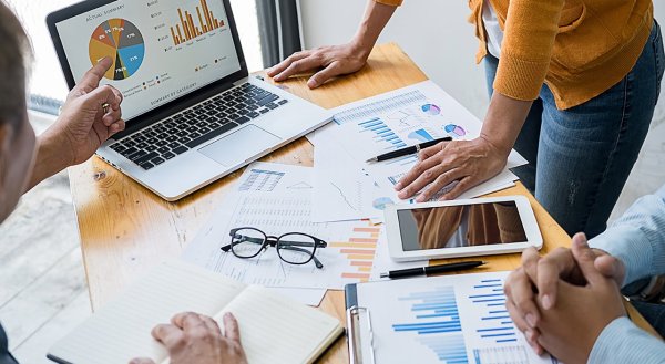 three people reviewing data visualizations together