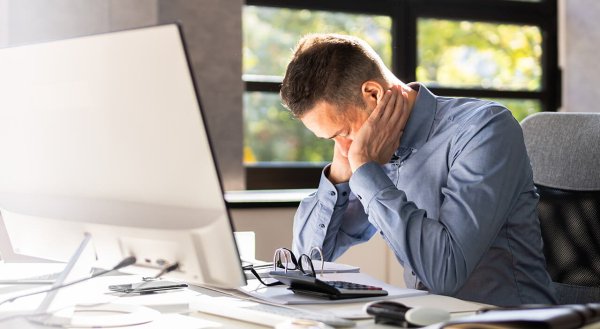 tired man falling asleep at his desk