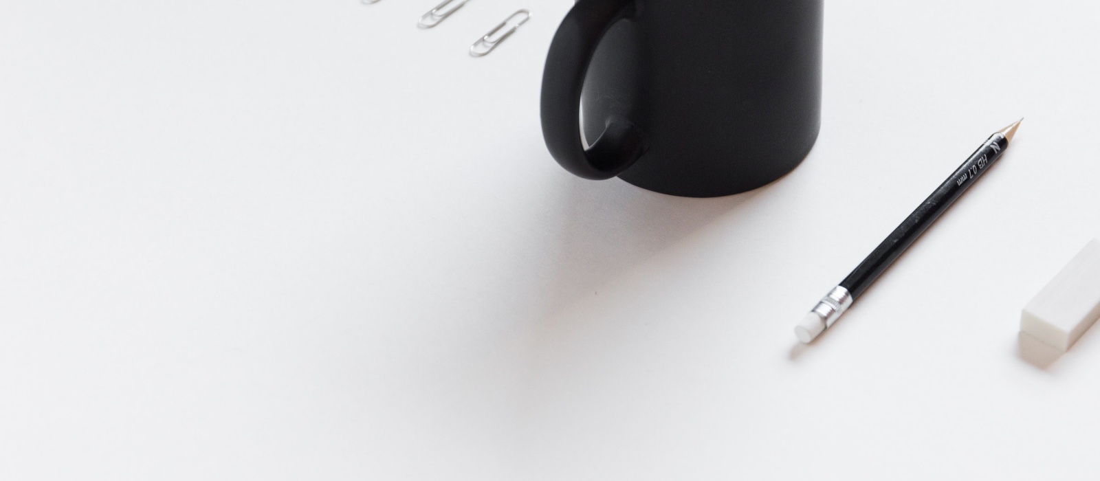 coffee mug and stationary items on a desk