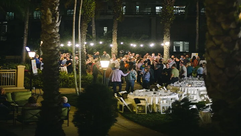 outdoor party with palm trees at night