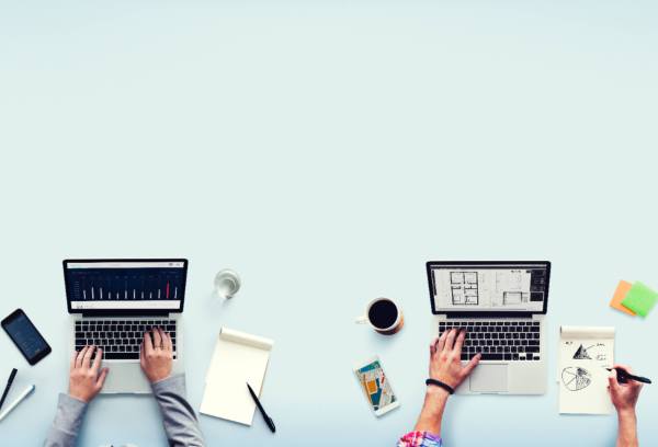 two people working on laptops