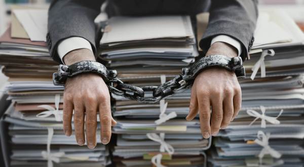 man imprisoned by file folders