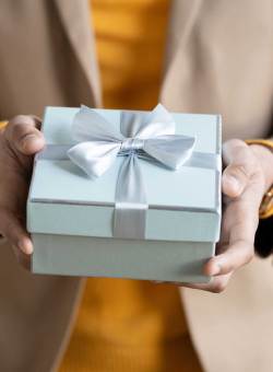 Image of person holding a gift box.