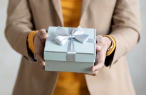 Image of person holding a gift box.