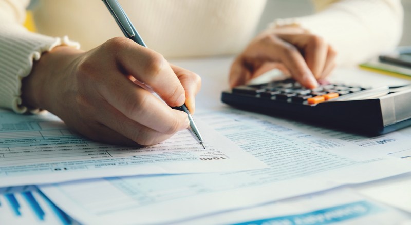 person filling out a tax form