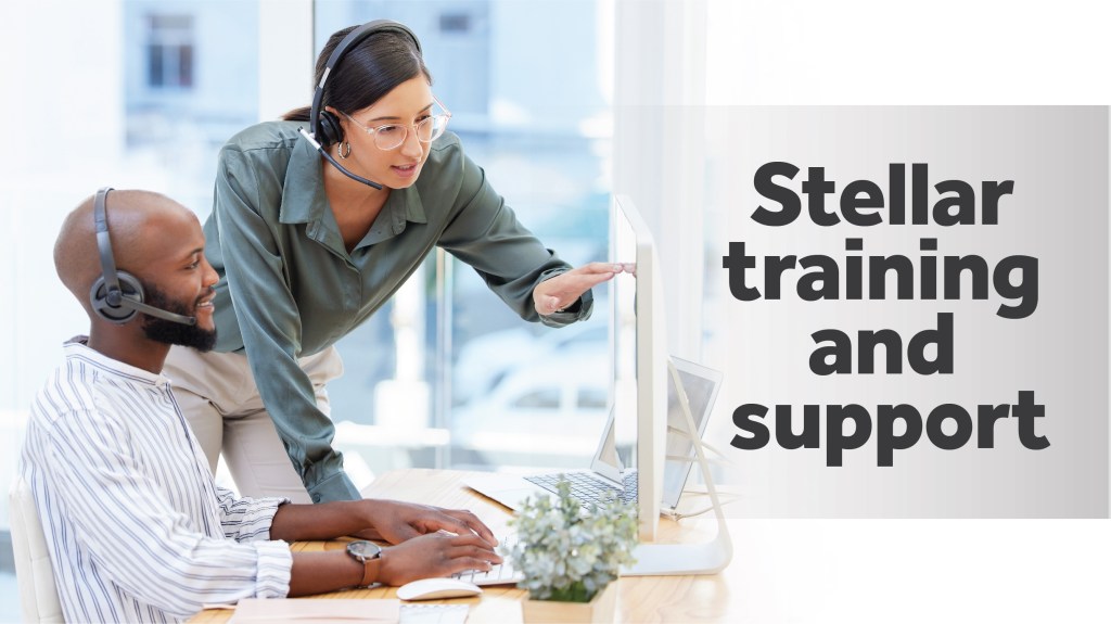 Two smiling, friendly employees wearing headsets in a business environment providing training and support.